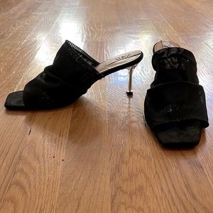 Black mesh slip on sandals.